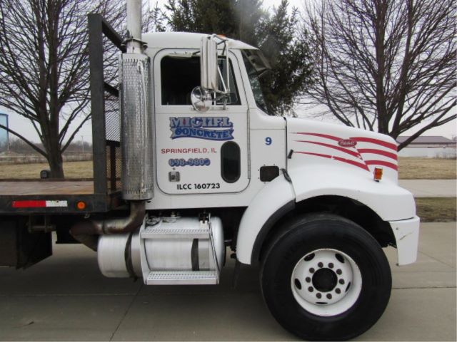 Peterbilt truck side view showing company logo and contact details on door, fuel tank, steps, and red decorative stripes on white cab.