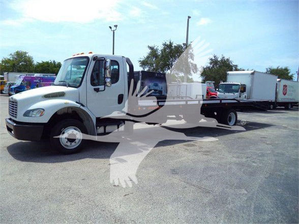 2012 Freightliner Business Class M2 106 flatbed truck in a lot with other vehicles visible in background.