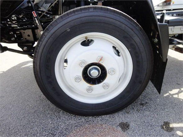 Isuzu NPR HD wheel and tire with white steel rim and lug nuts visible.