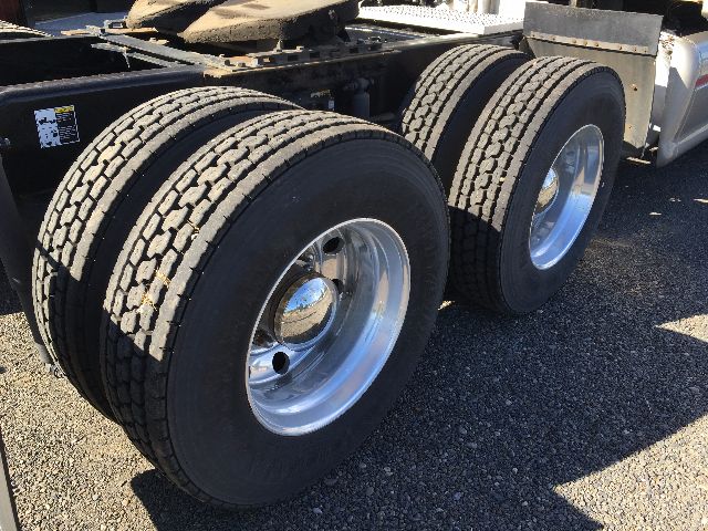 Peterbilt 578 chassis with dual rear axles and large black tires, chrome wheel hubs visible.