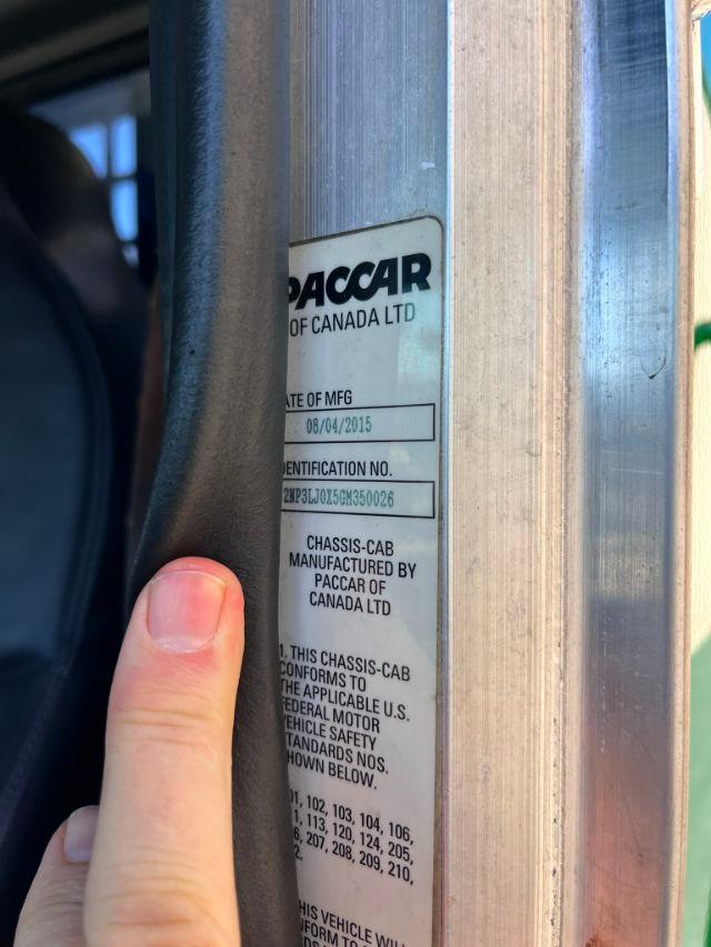 Paccar of Canada Ltd chassis-cab label on door frame with manufacturing date and identification number visible.