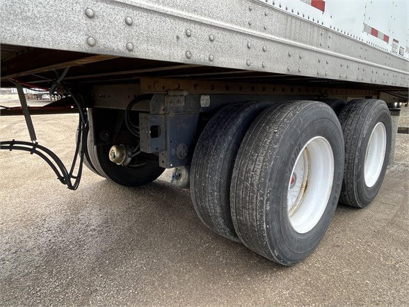 Great Dane dry van trailer with triple axle wheels and undercarriage view showing rear dual tires and frame.