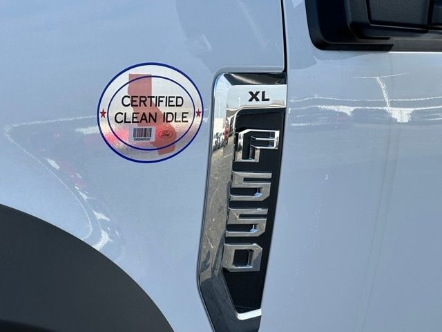 Ford F-550 XL badge on door with Certified Clean Idle sticker visible.