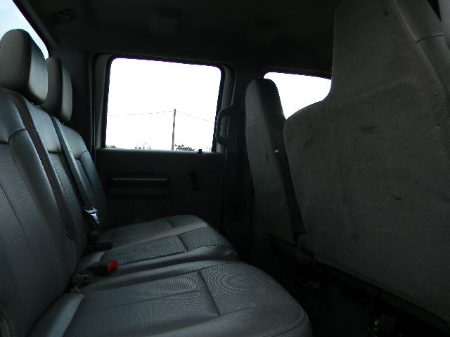 Ford F-750 interior rear seat view showing gray fabric seats and rear door panel.