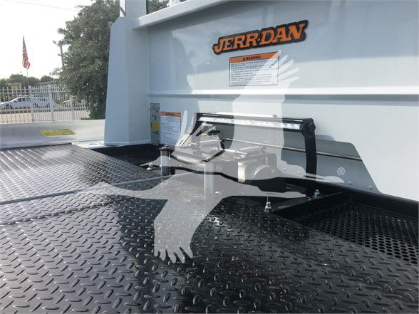 Truck bed of a 2022 Peterbilt 337 with a scalar platform and a metal diamond plate surface. The rear cab area shows a logo sticker 'JER-R-DAN' and a small caution label.
