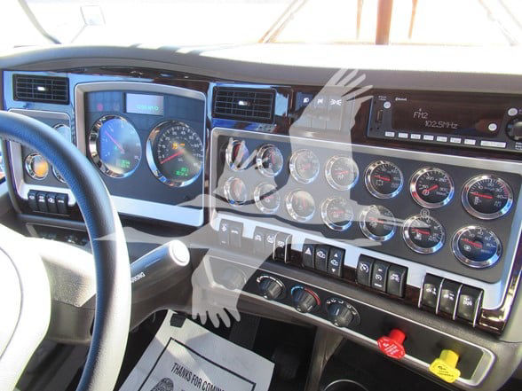 Kenworth W900L truck dashboard and instrument cluster with multiple gauges and controls.