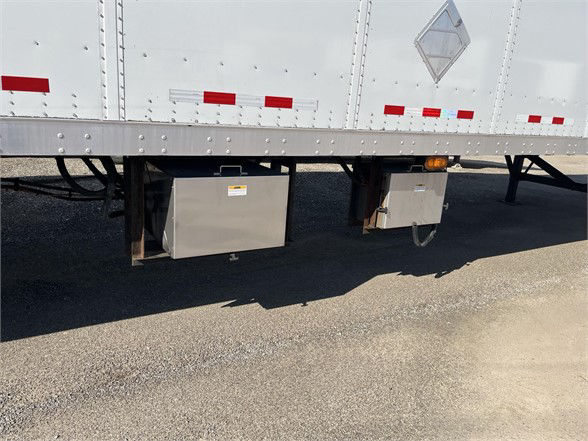 Trailer undercarriage showing two toolbox boxes mounted beneath a white Vanguard dry van trailer.