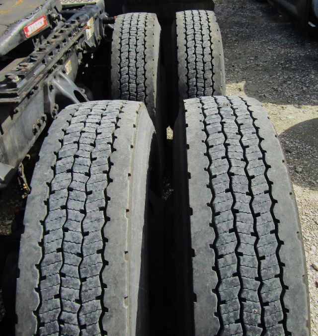 Truck chassis showing four dual rear tires with tread pattern visible.