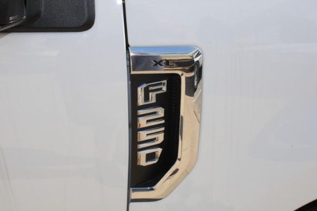 Ford F-250 XL badge on white pickup door, chrome trim