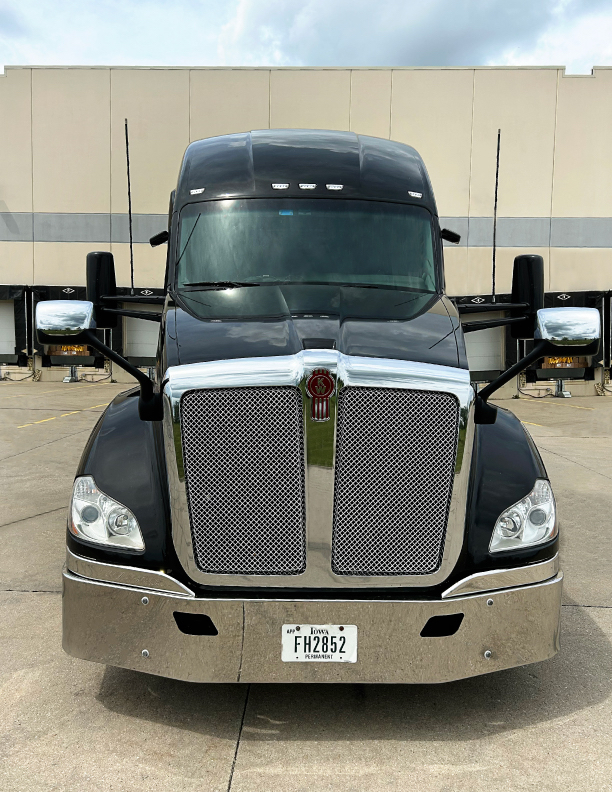 Front view of a 2020 Kenworth T680 truck with black cab and chrome grille, Iowa permanent license plate FH2852, large grille and headlights.