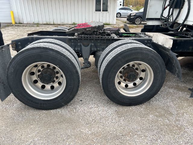 Dual rear axles with large heavy-duty tires and silver rims attached to truck chassis. Frame and fifth wheel area visible. No identifiable text.