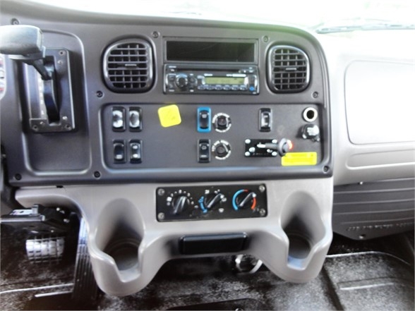 Dashboard cockpit of 2014 Freightliner Business Class M2 106 showing control panel with vents, radio, switches, gauges, and climate controls.