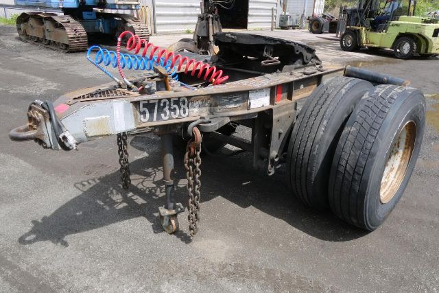 Fruehauf ELFI trailer chassis showing dual rear tires, hitch, chains, and coiled air lines.