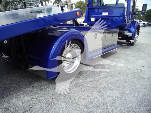 Kenworth T280 tow truck side view showing wheel, blue chassis, and undercarriage components.