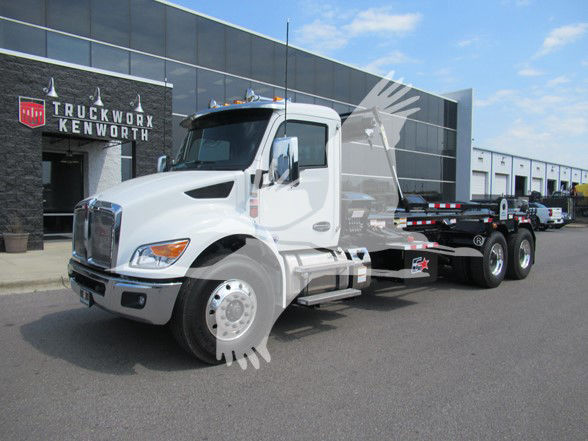 Kenworth T480 truck in front of dealership showing cab and chassis with white paint.