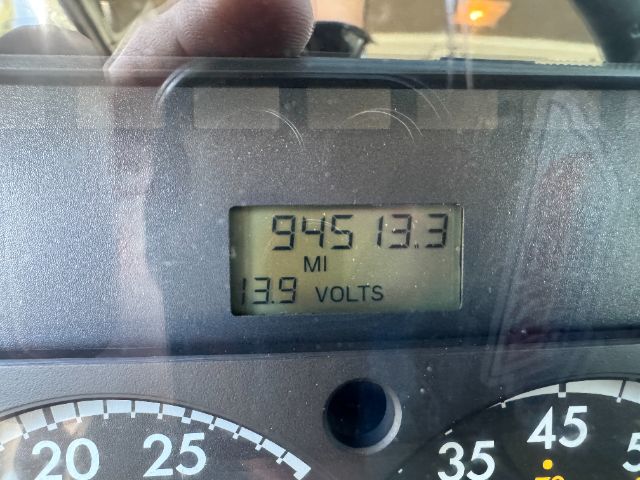 Gauge cluster and digital display showing 94513.3 miles and 13.9 volts in a Sterling L8500 vacuum truck.