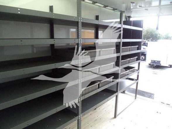 Box truck shelving with metal racks in a trailer or showroom, empty shelves, Chevrolet Silverado 6500HD unspecified details.