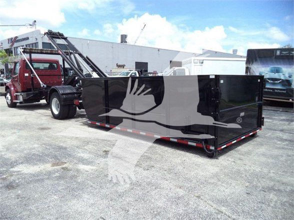 Freightliner Business Class M2 106 roll-off truck with large black dump body. No legible labels or model text visible on body.