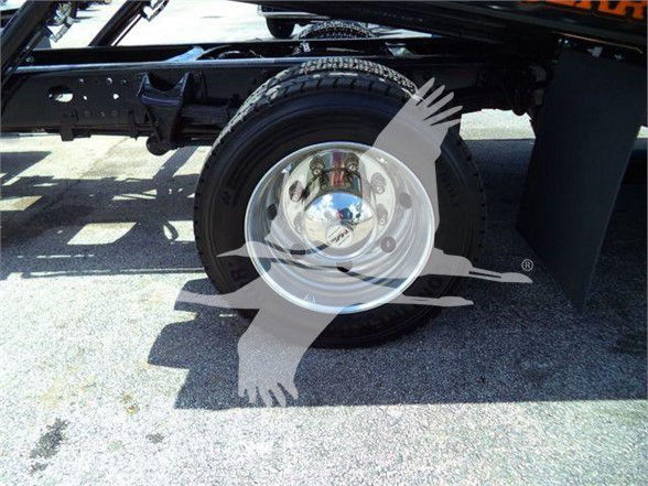 Truck wheel and chassis framing with spare wheel cover showing Chevrolet Silverado 6500HD tag and stock information.