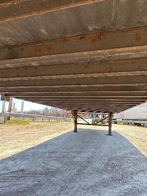 Wabash DuraPlate dry van trailer undercarriage with frame rails and support legs visible.