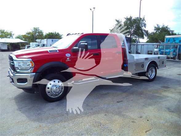 Ram 5500 flatbed truck in red with chrome front grille and dual rear wheels, watermark overlay of a bird and hands covering center of image.