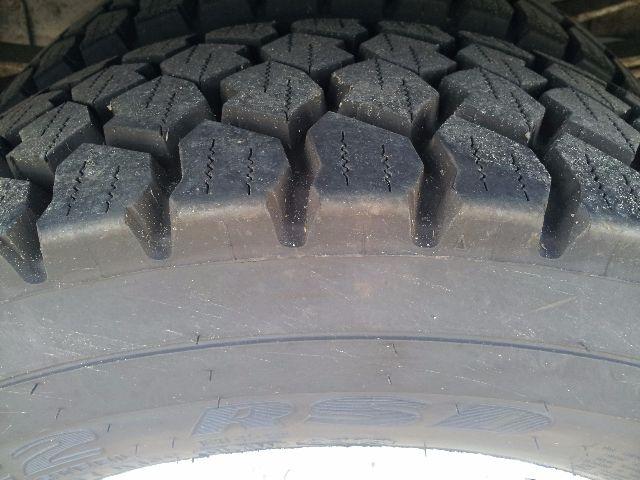 Close-up of tire tread on a Workhorse P42 showing rugged block pattern and load-bearing rubber.