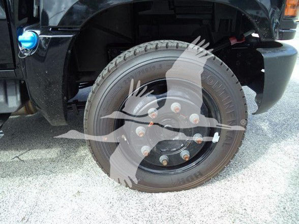 Chevrolet Silverado 6500HD wheel and tire with hub and lug nuts visible in front fender area.