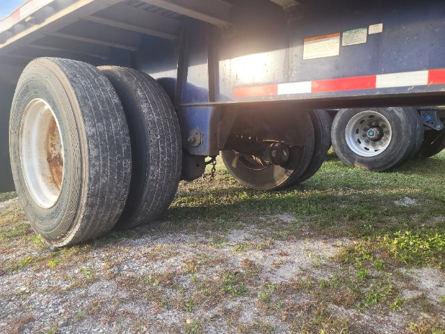 Great Dane 48X102 flatbed trailer undercarriage showing dual rear axle with tires and suspension components.