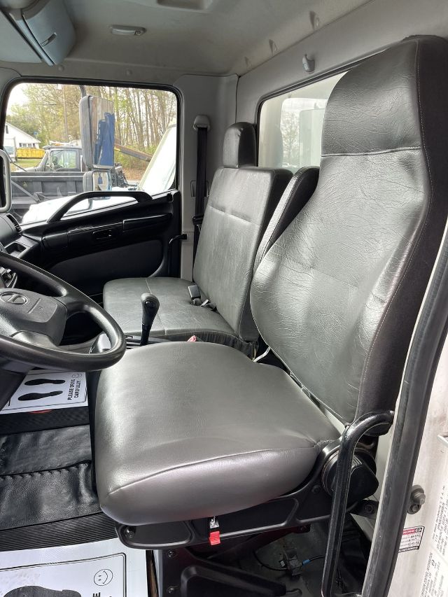 Interior of a 2017 Hino 268 box truck cab showing driver and passenger seats, steering wheel, and gear shifter.