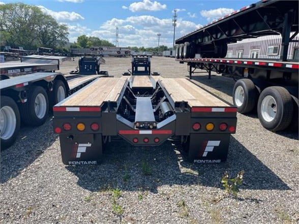 Fontaine 55 ton steel roller paver lowboy trailer rear view showing wooden deck and branding, with taillights and mud flaps.