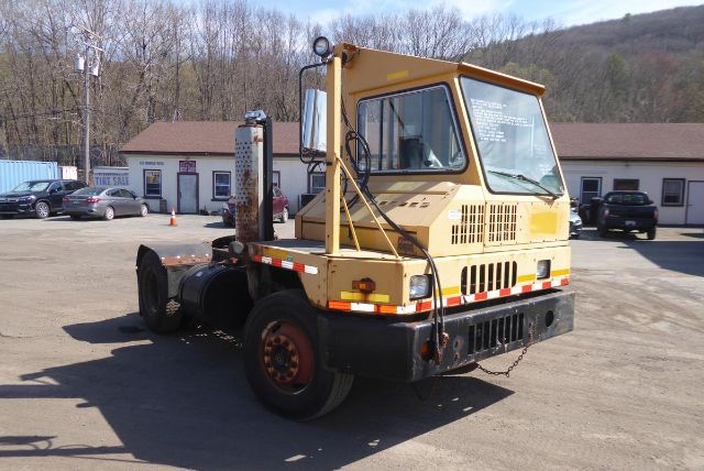 Kalmar 4x2 yard truck in beige with cab-over design, side exhaust, rear diesel tank, in a reconditioned lot.