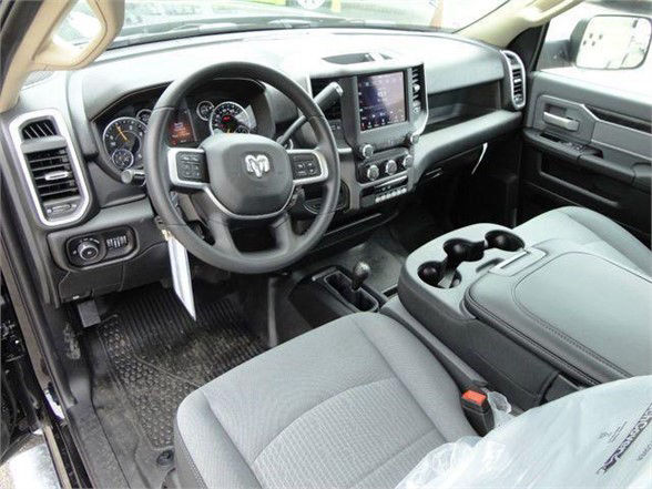 Ram 4500 SLT truck interior showing steering wheel with Ram logo, center touchscreen, and large console with cupholders.