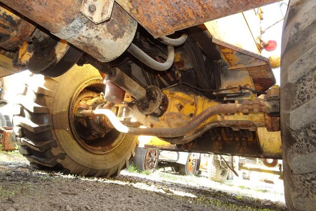 Grove RT58 crane chassis underside showing axle, suspension, and hydraulic lines.