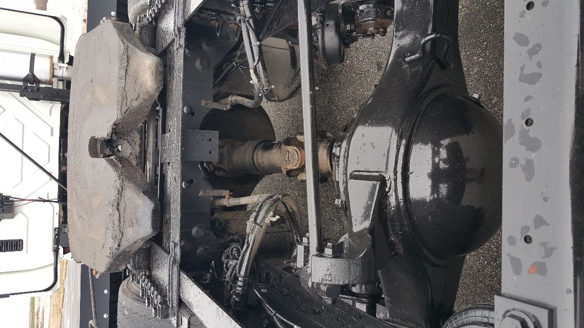 Truck chassis rear view showing drive shaft, suspension, and fuel tank mounts on a 2007 International 8600 cab-over or conventional truck.
