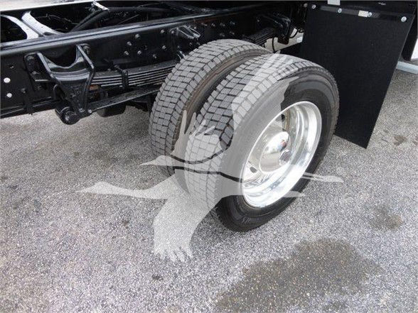 Truck wheel and rear axle assembly showing dual rear tires and suspension components.