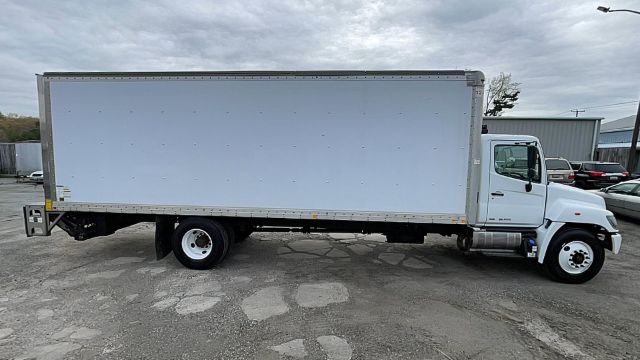 Box truck side profile showing cargo box and cab, white exterior, two-axle chassis, Hino 268 box truck.