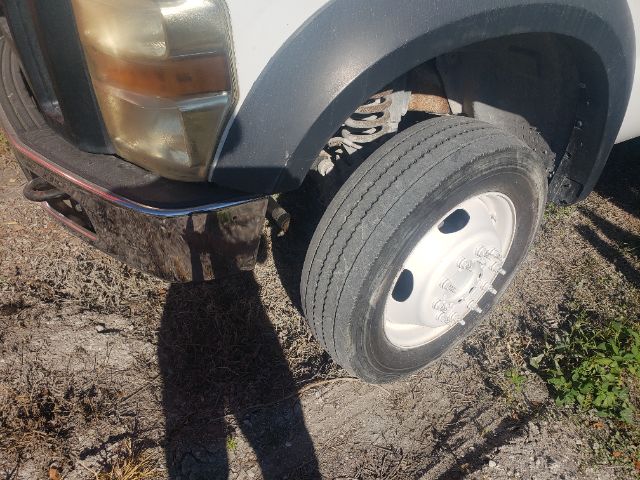 Front left wheel and fender of a 2008 Ford F550 with dual tires and headlamp visible.
