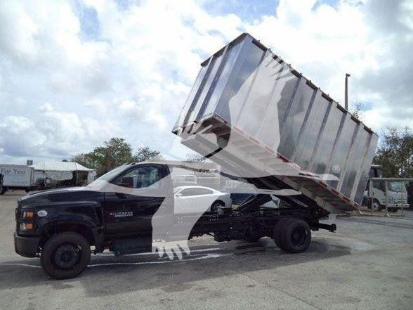 Truck with dump bed raised showing Chevrolet Silverado 6500HD, side view, with VIN and stock details not visible on image.