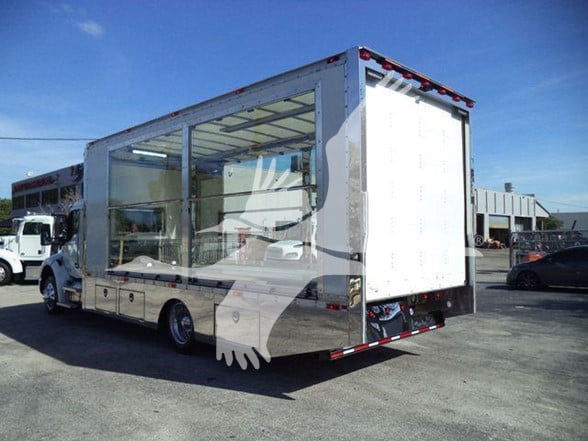 Kenworth T280 truck with open service body, side and rear doors visible, showroom white with reflective panels.