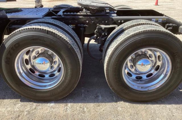 Peterbilt 579 truck rear dual wheels with chrome hubcaps and tires, chassis and undercarriage visible.