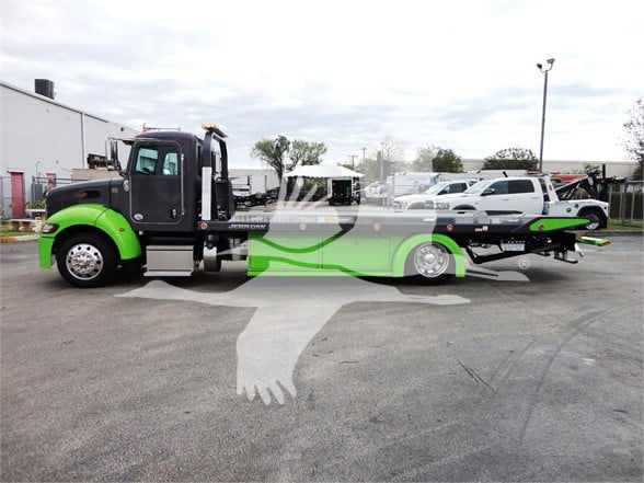 Peterbilt 337 tow truck with lime green and black cab and long green chassis, side profile view.