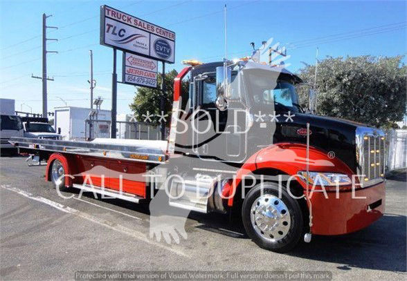Peterbilt 337 tow truck in red and black with flatbed, front chrome bumper, large side mirrors, and stock number J04652.