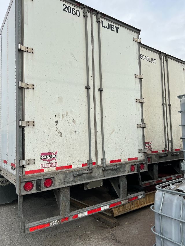 2015 Wabash 53' dry van trailer rear view with double doors, steel frame, and reflective tape along bottom edge.