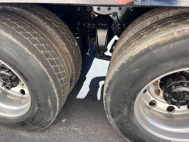 Freightliner M2 106 rollback truck dual rear wheels showing suspension and tires.