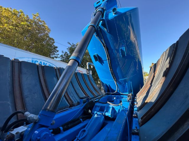 Blue Sterling L7500 vacuum truck bed side with hydraulic rams and large dumping container visible inside.
