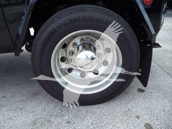 Wheel and tire of a new 2025 International MV truck showing a shiny steel rim and Continental tire; partial fender and chassis visible.