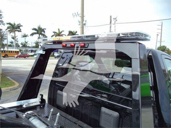 Ram 4500 SLT truck rear window area with decal of a dragon or abstract logo on the back window and a high-mounted brake light.