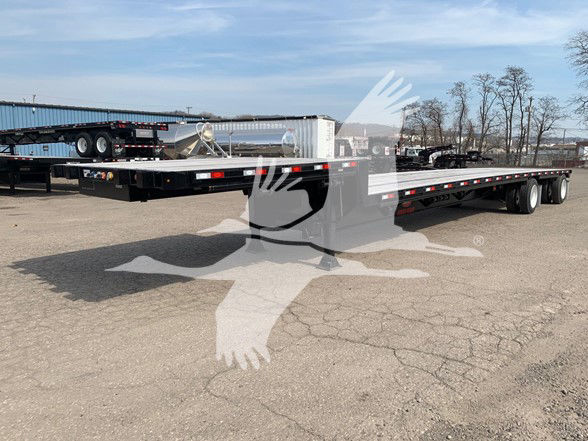 2020 Dorsey dropdeck trailer with long flat deck and tandem rear axles in an outdoor lot.