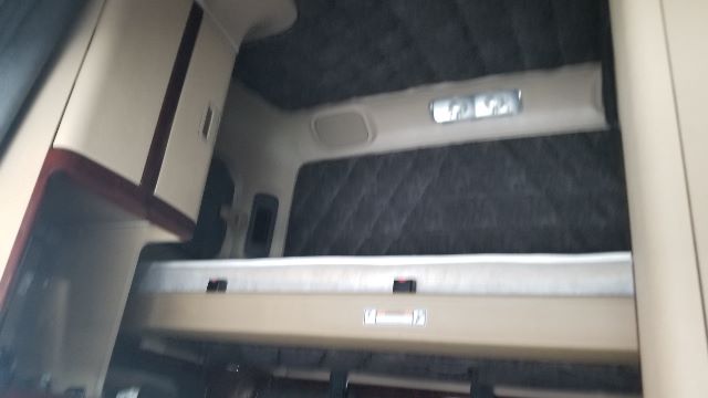 Truck cab interior with a metal step and beige trim. No legible labels or numbers clearly visible.