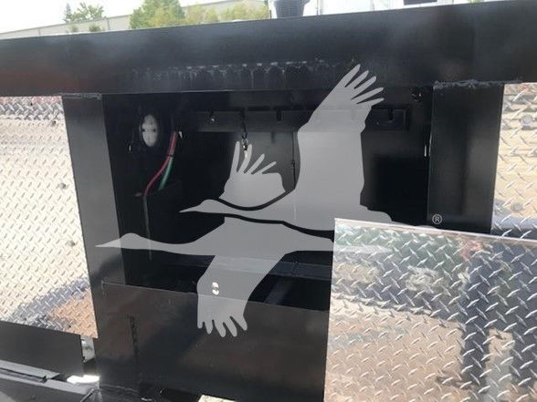 Trailer rear frame with aluminum pullouts and diamond plate, showing a gauge and wiring inside a black metal structure.